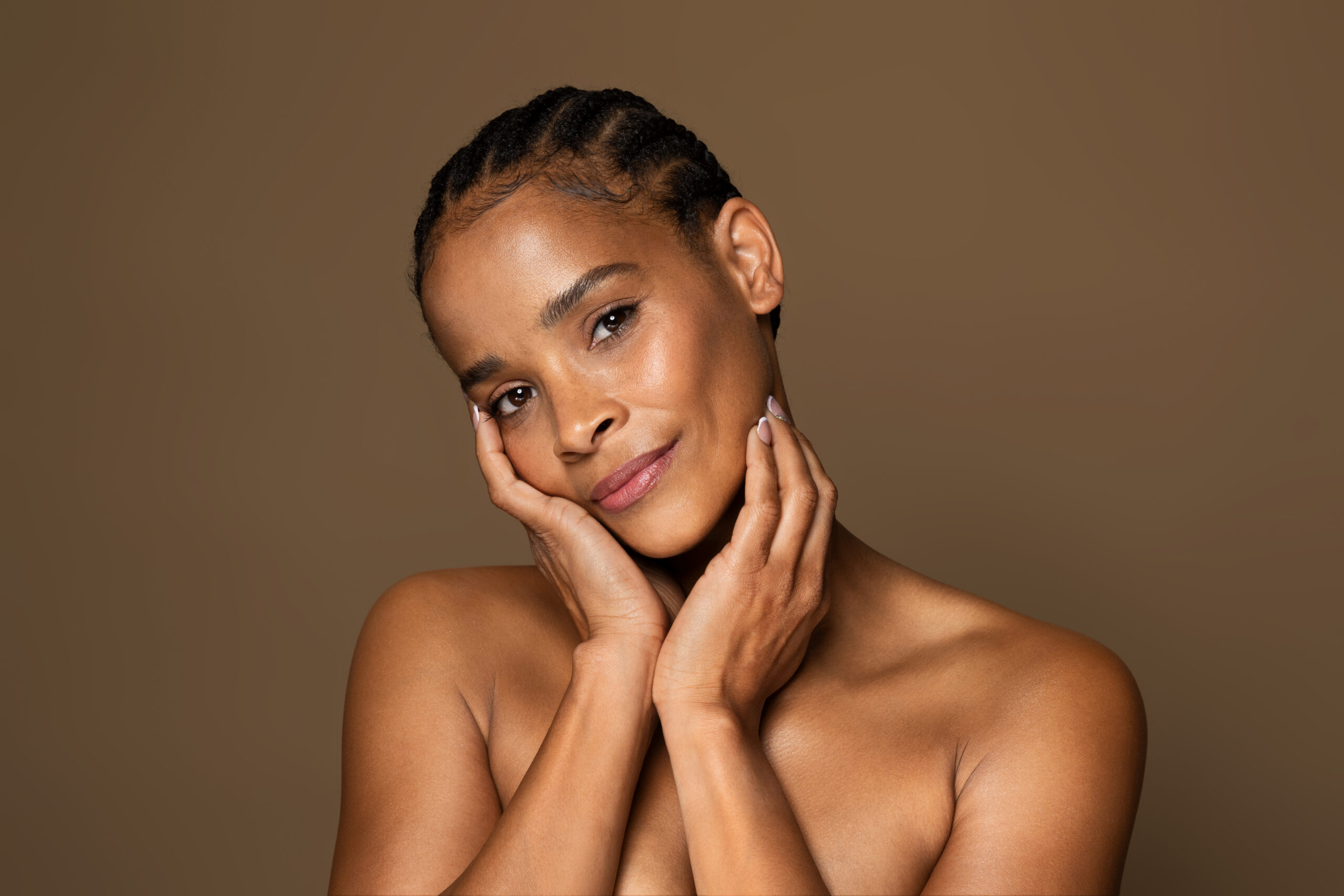 Antiage skincare concept. Beautiful black middle aged woman with flawless skin touching face and looking at camera - Welcome to Vanguard Dermatology - Vanguard Dermatology | Dermatology Services Derm of Cape Cod